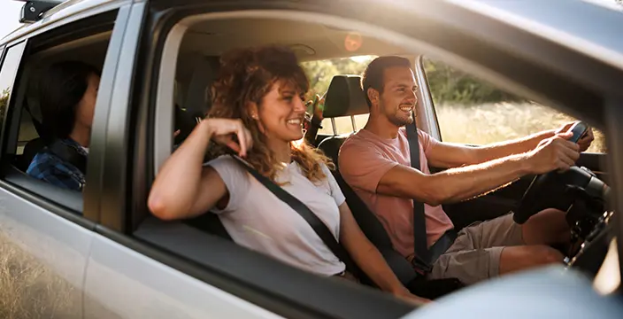 Man and woman driving in car