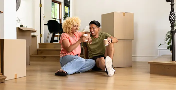 Couple sitting next to moving boxes