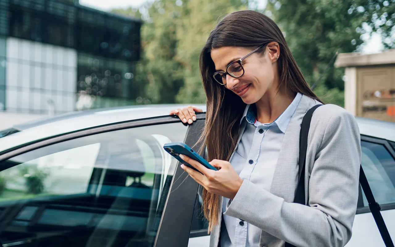 Woman standing by car