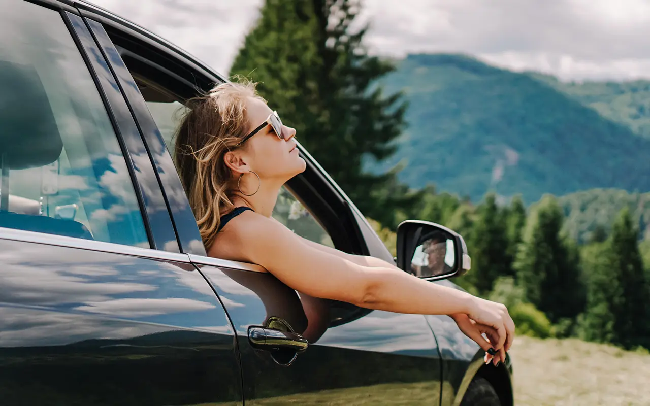Woman leaning out of car