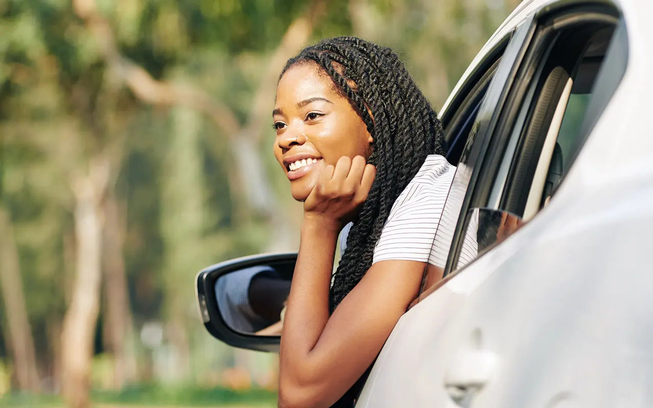 Woman leaning out of car
